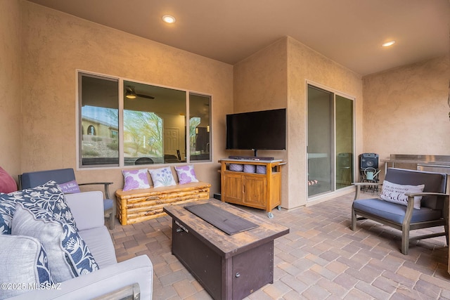 view of patio / terrace with an outdoor living space with a fire pit