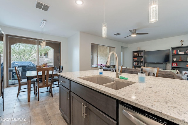 kitchen with dishwasher, a sink, pendant lighting, and visible vents
