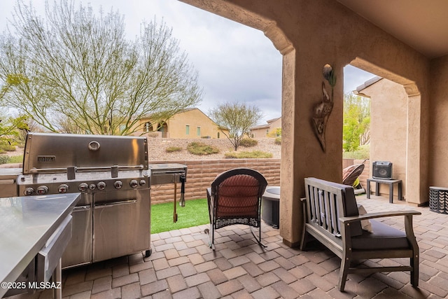 view of patio with grilling area and fence