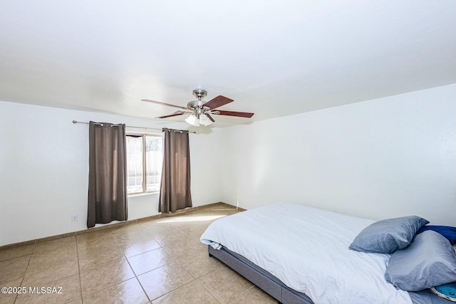 bedroom featuring light tile patterned floors and ceiling fan