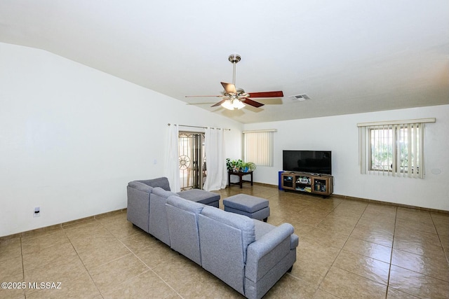 living area featuring light tile patterned floors, lofted ceiling, visible vents, and a ceiling fan