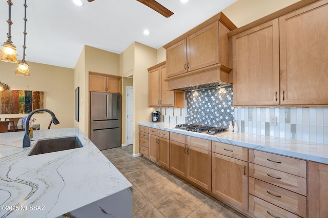 39425 S Mchaney Ct, Tucson, AZ 85739 - kitchen with decorative backsplash, hanging light fixtures, a sink, light stone countertops, and appliances with stainless steel finishes