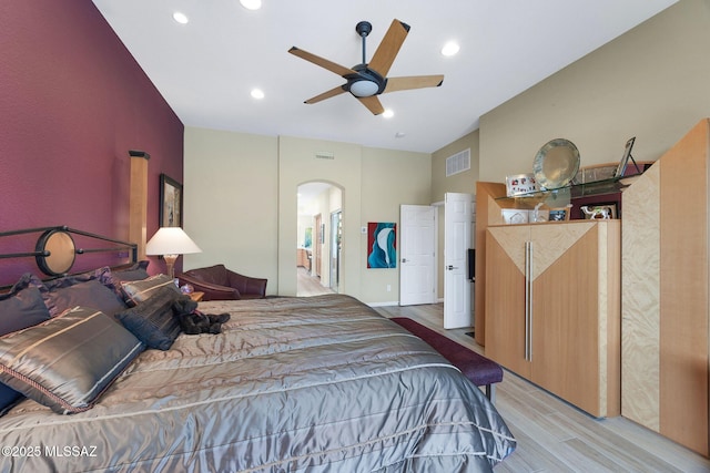 39425 S Mchaney Ct, Tucson, AZ 85739 - bedroom with light wood-type flooring, visible vents, arched walkways, and recessed lighting