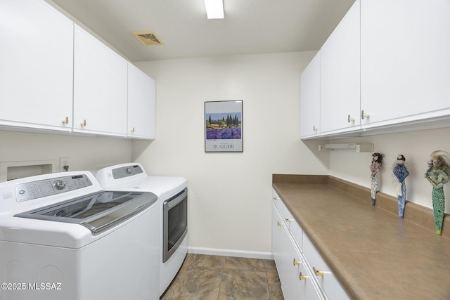 39425 S Mchaney Ct, Tucson, AZ 85739 - laundry area with washer and clothes dryer, visible vents, cabinet space, and baseboards