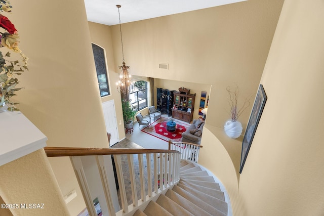 39425 S Mchaney Ct, Tucson, AZ 85739 - stairs featuring an inviting chandelier, a towering ceiling, and visible vents