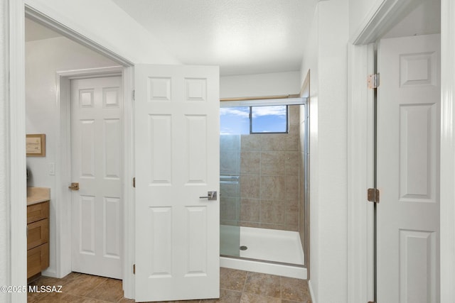 39425 S Mchaney Ct, Tucson, AZ 85739 - bathroom with vanity, a textured ceiling, and a shower stall