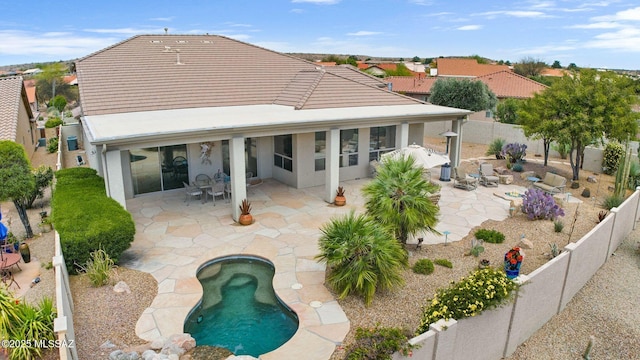 39425 S Mchaney Ct, Tucson, AZ 85739 - back of house with a fenced backyard, a tiled roof, and a patio