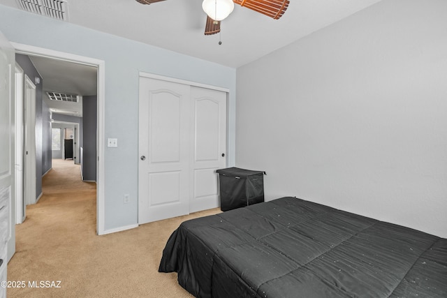 bedroom with visible vents, a closet, ceiling fan, and carpet