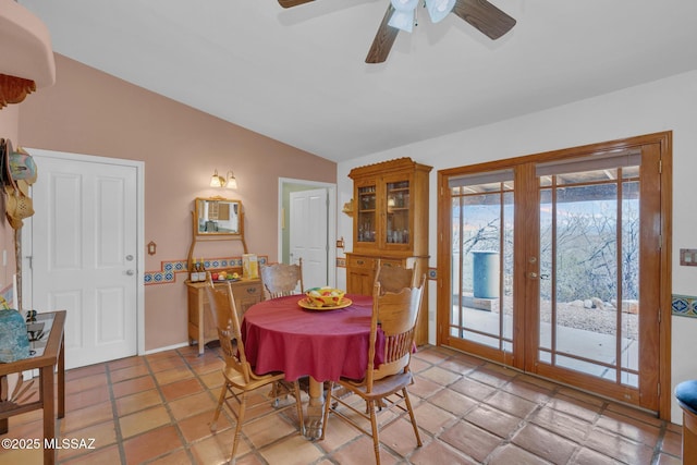 dining space featuring lofted ceiling, a ceiling fan, and french doors