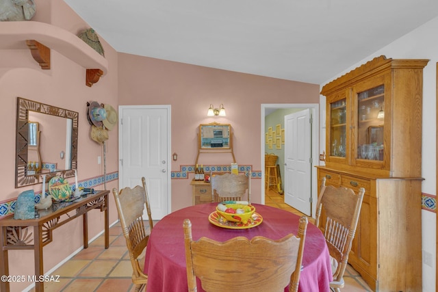 dining space featuring light tile patterned floors