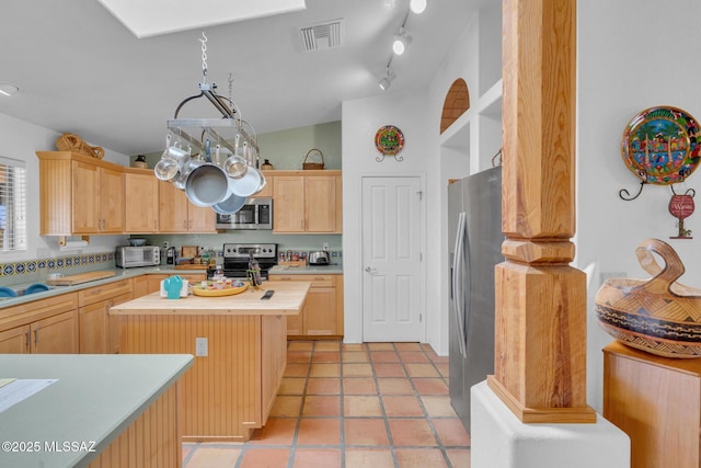 kitchen with butcher block counters, light brown cabinets, visible vents, and appliances with stainless steel finishes