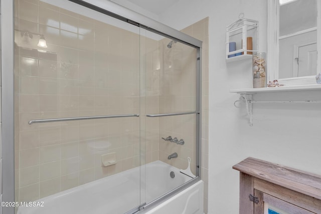 bathroom featuring combined bath / shower with glass door