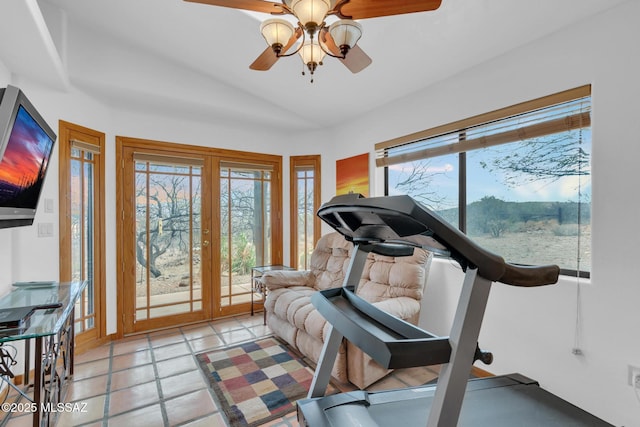 exercise area featuring vaulted ceiling, light tile patterned floors, ceiling fan, and french doors