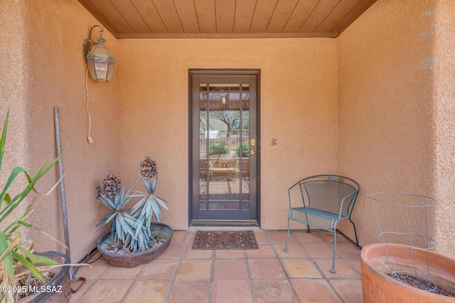 view of exterior entry featuring stucco siding