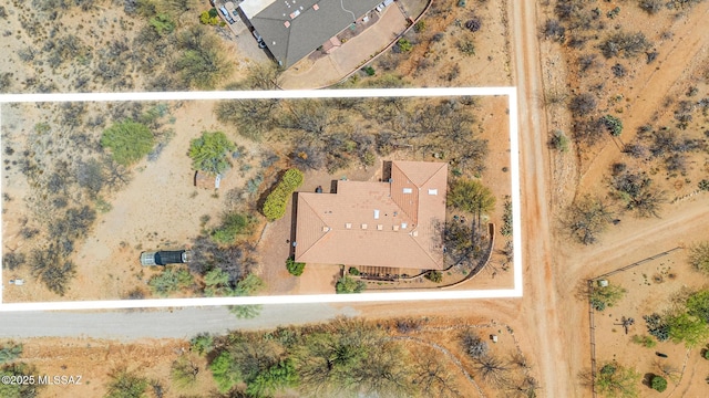 bird's eye view with view of desert and a rural view