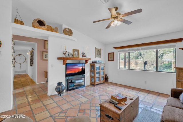 living area with lofted ceiling, a ceiling fan, and light tile patterned flooring