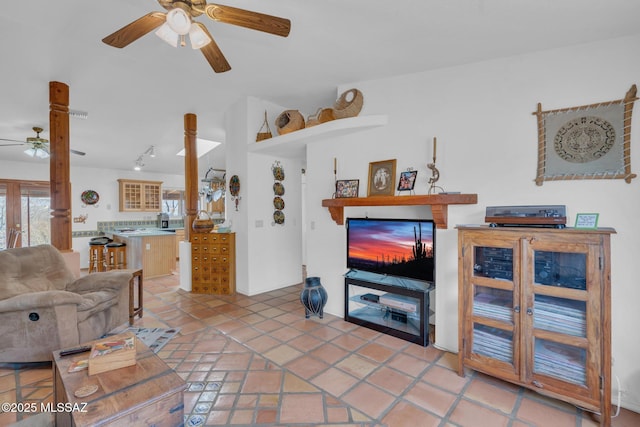 living room featuring rail lighting, a ceiling fan, and light tile patterned floors