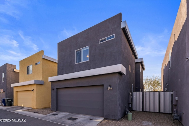 view of side of home with stucco siding and a garage