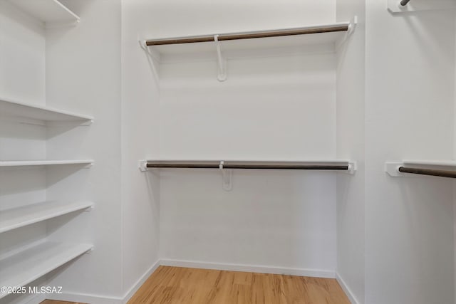 spacious closet with wood finished floors