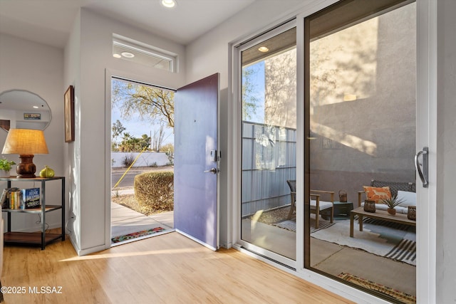 doorway to outside featuring wood finished floors and recessed lighting