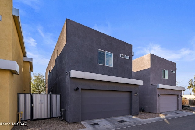 view of side of home with stucco siding and a garage