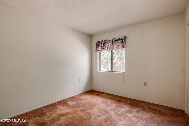 carpeted empty room with a textured ceiling