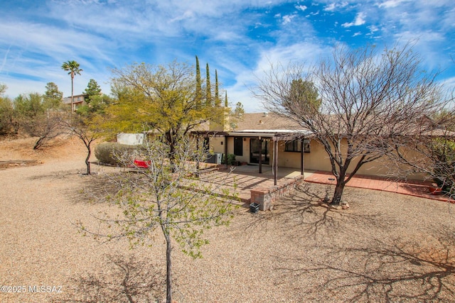 back of property featuring stucco siding and a patio area