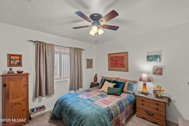 carpeted bedroom with baseboards and a ceiling fan