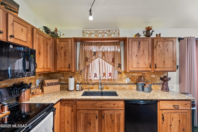 kitchen with brown cabinetry, a sink, black appliances, and backsplash