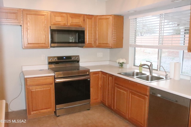 kitchen with light countertops, a sink, and appliances with stainless steel finishes