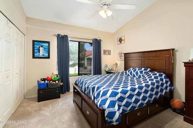 bedroom with light carpet, a closet, vaulted ceiling, and ceiling fan