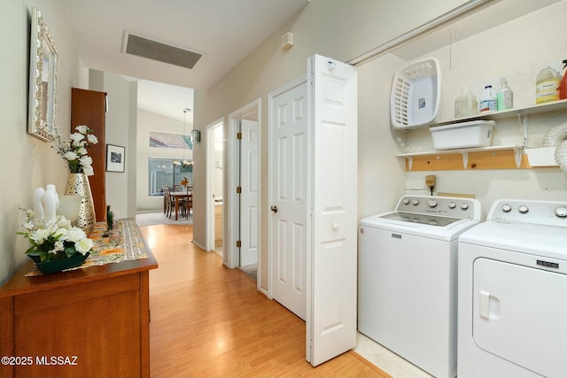 laundry area with independent washer and dryer, laundry area, visible vents, and light wood-style floors