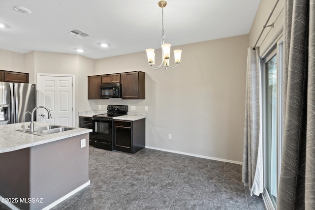12272 W Reyher Farms Loop, Marana, AZ 85653 - kitchen with black appliances, dark brown cabinetry, light countertops, decorative light fixtures, and a chandelier