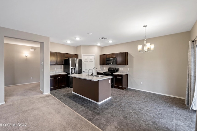 12272 W Reyher Farms Loop, Marana, AZ 85653 - kitchen featuring black appliances, a chandelier, dark brown cabinetry, a kitchen island with sink, and pendant lighting