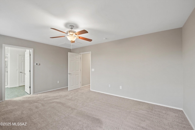 12272 W Reyher Farms Loop, Marana, AZ 85653 - unfurnished bedroom with light carpet, connected bathroom, and a ceiling fan