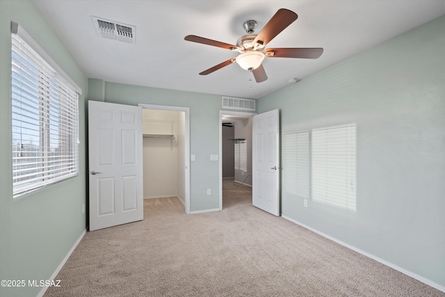 12272 W Reyher Farms Loop, Marana, AZ 85653 - unfurnished bedroom with carpet, a spacious closet, ceiling fan, and a closet