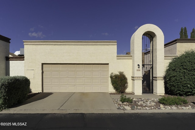 view of front of home featuring driveway, stucco siding, and an attached garage