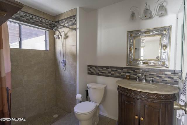 full bath with toilet, vanity, tile patterned floors, and tiled shower