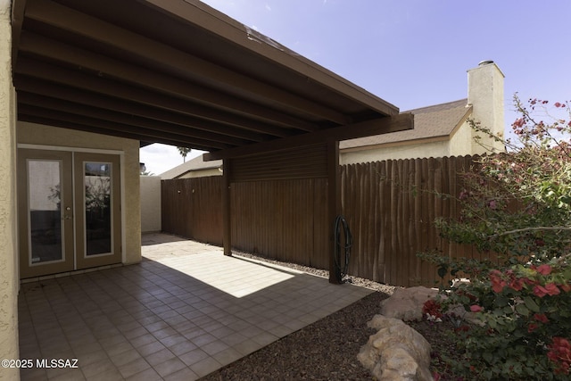view of patio / terrace with fence and french doors