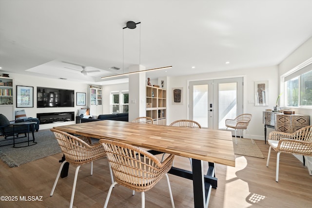 dining room featuring light wood finished floors, french doors, and recessed lighting