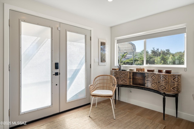 doorway featuring baseboards and light wood-style flooring