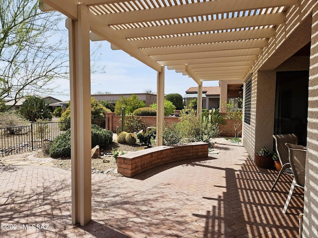view of patio / terrace featuring a pergola and fence