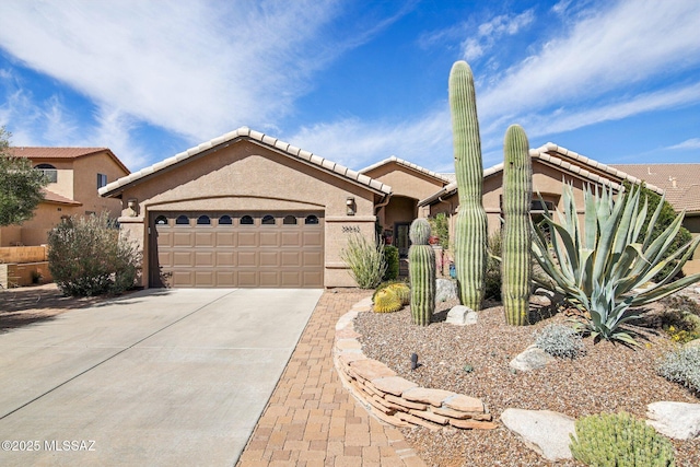 single story home with stucco siding, a tiled roof, concrete driveway, and an attached garage