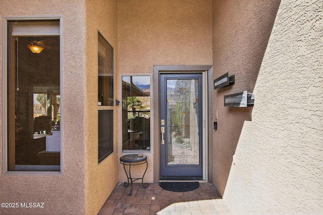 property entrance with stucco siding