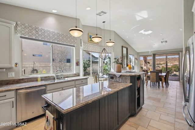kitchen featuring white cabinets, visible vents, appliances with stainless steel finishes, and a sink