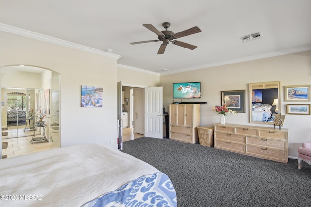 bedroom with crown molding, visible vents, carpet floors, arched walkways, and a ceiling fan
