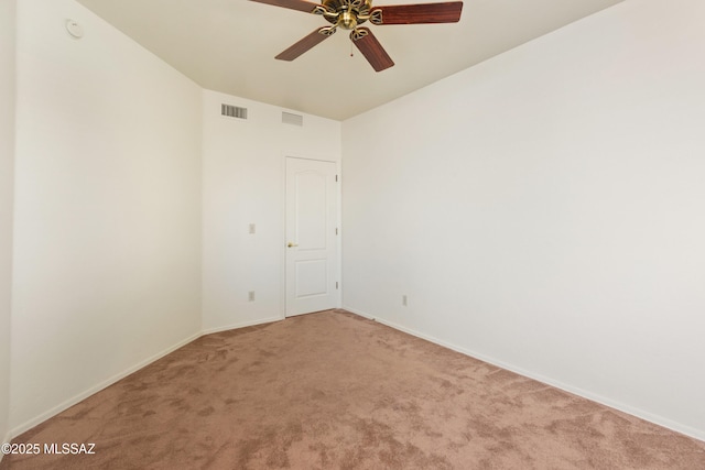 spare room with light carpet, baseboards, visible vents, and ceiling fan