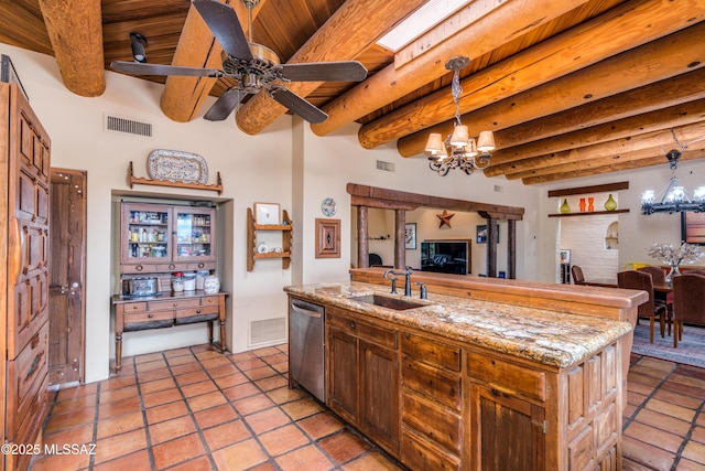 kitchen with ceiling fan with notable chandelier, a sink, beamed ceiling, visible vents, and dishwasher
