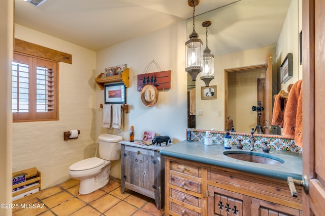 bathroom featuring tile patterned floors, toilet, and vanity