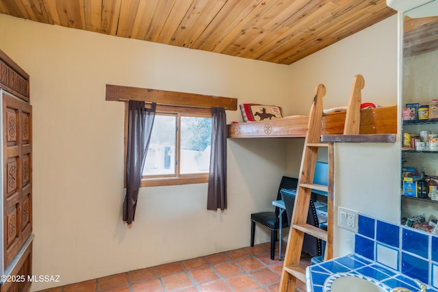 bedroom with tile patterned flooring and wooden ceiling